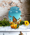 Elegant blue butterfly urn for respectfully keeping adult female human ashes after cremation.