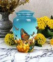 Elegant blue butterfly urn for respectfully keeping adult female human ashes after cremation.