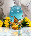 Elegant blue butterfly urn for respectfully keeping adult female human ashes after cremation.