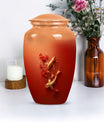 Gold fish urn with butterfly theme, ideal for memorial ashes