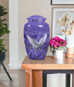 white dove on purple urn with butterfly theme.